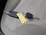 a car key and a car keychain sitting on the seat of a car