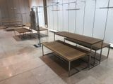 several tables and benches are lined up in a row in a room