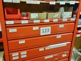 a red filing cabinet with lots of boxes on it
