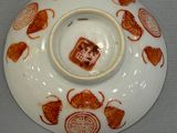 a white plate with a red design on it