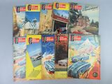 six livres posés sur une table, avec une photo de voiture en arrière-plan