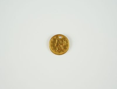 gros plan d'une pièce d'or sur une surface blanche