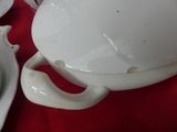 a white bowl of food on a red table cloth