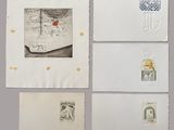 several pieces of paper with drawings on them on top of a table