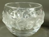 a clear glass bowl with a flower design on it