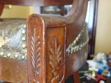 a wooden chair with a floral design on it