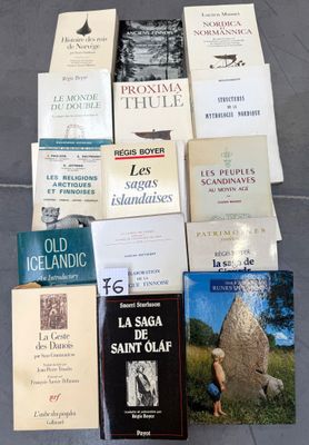 several books are stacked on top of each other on the ground