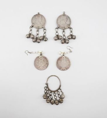 three pairs of silver earrings and a silver coin