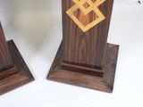 two wooden bookends that have a design on them