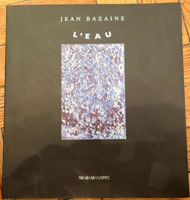 a book on a wooden table with a black cover