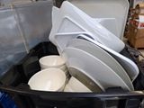 a black container filled with white dishes and bowls