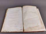 an open book with a white cover on a table