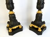 pair of antique black and gold candlesticks on stands