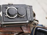 a small camera sitting on top of a brown bag