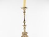 a silver candle holder with a candle on top of it