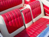a red and white car with two seats in it