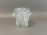 a frosted glass cup with a handle on a table
