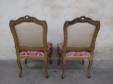 pair of antique french style chairs with pink upholstered cushions