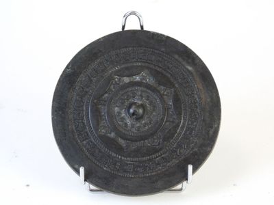 a black plate with a circular design on it