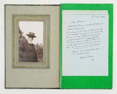 an old photo of a man in a hat and suit