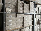 boxes are stacked on a shelf in a storage room