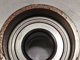 an image of a close up of a metal plate with a bearing on it