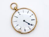 a gold pocket watch with roman numerals on the face
