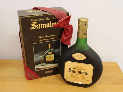 a bottle of wine sitting on a table next to a box