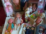a lot of dolls that are sitting on the floor