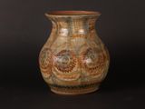 a vase that is sitting on a black surface