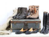 many pairs of shoes sitting on top of a suitcase