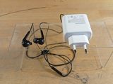 a charger and headphones sitting on a wooden table
