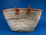 a close up of a woven basket bag on a blue background