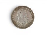 an old coin with a man ' s face on it on a white surface