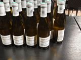 several bottles of wine are lined up on a table in a restaurant