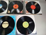 three black vinyl records sitting on top of a table next to each other