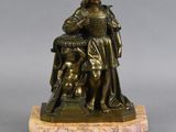 an image of a bronze statue of a man with a dog