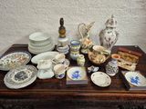a table with a lot of china and other items on it