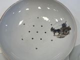 a white bowl with a horse drawn carriage on it