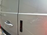a close up of a car door handle with a sticker on it