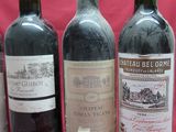 several bottles of wine are lined up on a red background