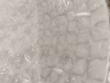 a close up of a bowl of food wrapped in plastic