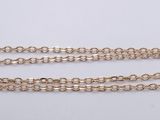 a pair of gold chain bracelets