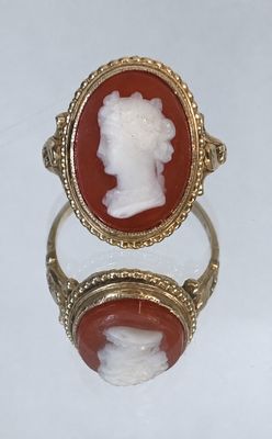 an image of a gold ring with a cameo of a woman ' s head
