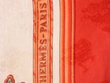 a close up of a red and white table cloth with a name plate on it