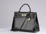 a black leather handbag on a white background