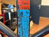a close up of a bike frame with a colorful sticker on it