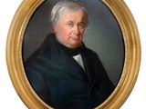portrait of a man in a black coat and a white tie