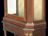 a wooden display case with a glass door on it