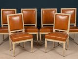 set of six chairs with leather upholstered backs and wooden legs